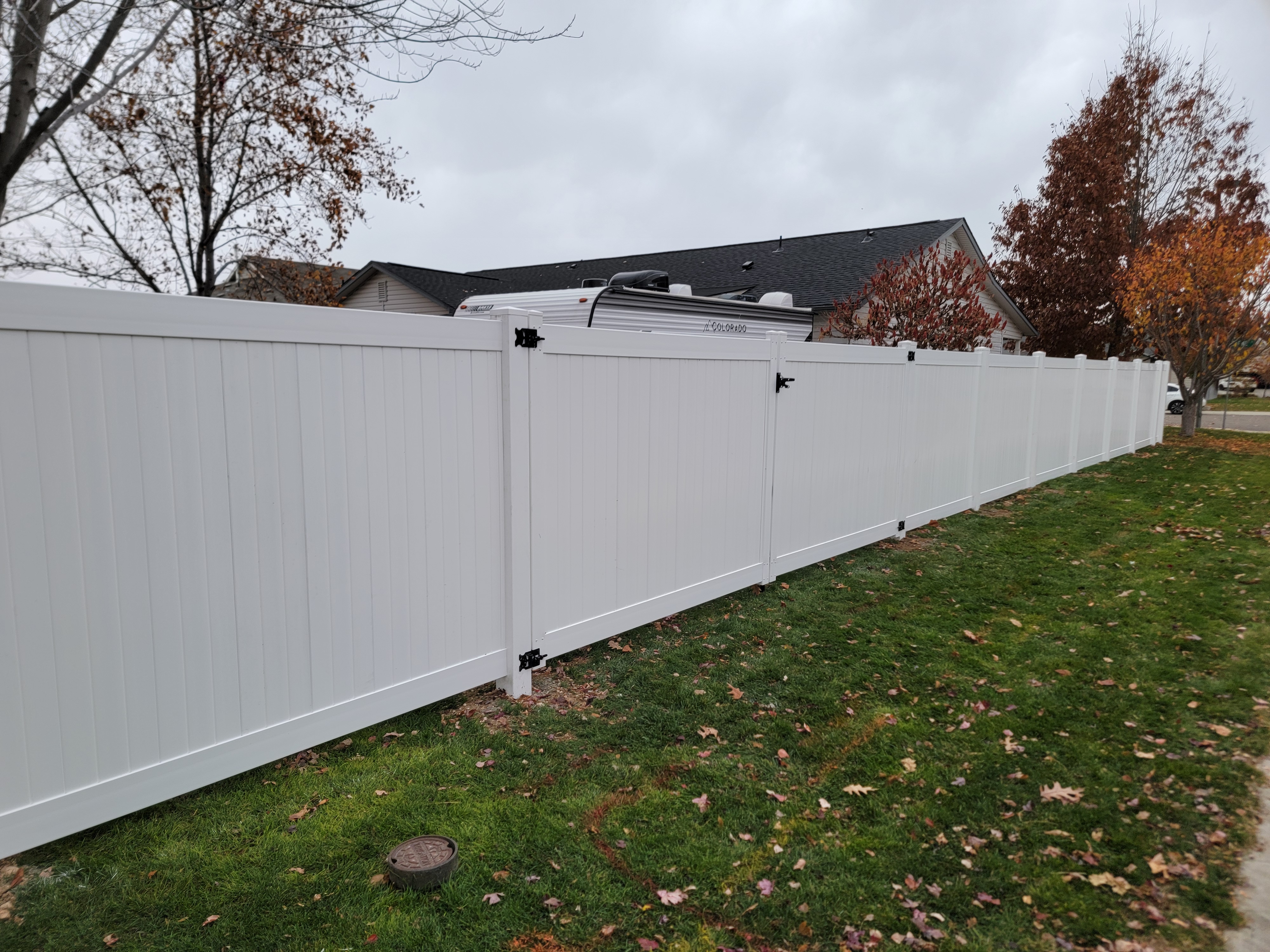White vinyl privacy fence with drive gate by Fence Craft